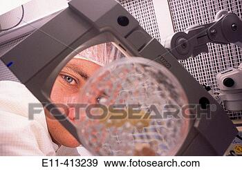Stock Photograph - pharmaceutical 
worker observes 
petri dish. fotosearch 
- search stock 
photos, pictures, 
images, and photo 
clipart