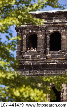Stock Photograph - three girls looking 
out from a window 
of the porta nigra 
trier. fotosearch 
- search stock 
photos, pictures, 
images, and photo 
clipart