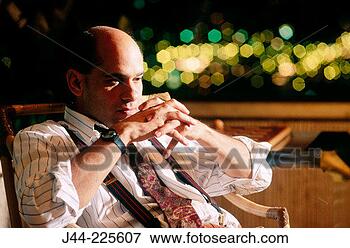 Picture - businessman sitting 
on a terrace late 
at night. fotosearch 
- search stock 
photos, pictures, 
images, and photo 
clipart