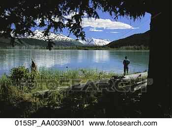 Stock Photography - man spin fishing 
at kenai lake 
kenai mtns summer. 
fotosearch - search 
stock photos, 
pictures, images, 
and photo clipart