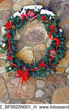 Stock Photo - snow dusted holiday 
wreath hanging 
on outside of 
house colorado 
winter. fotosearch 
- search stock 
photos, pictures, 
images, and photo 
clipart