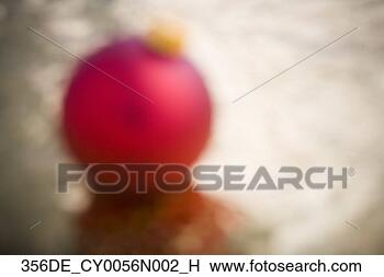 Stock Photo - one red christmas 
ball on gold wrapping 
paper blurred. 
fotosearch - search 
stock photos, 
pictures, images, 
and photo clipart