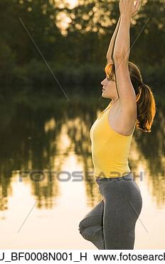 Stock Photo - woman in yoga 
position on dock 
of lake @ sunset 
southcentral alaska. 
fotosearch - search 
stock photos, 
pictures, images, 
and photo clipart