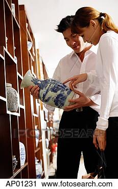 Stock Photography - couple looking 
at chinese vase 
in antique shop. 
fotosearch - search 
stock photos, 
pictures, images, 
and photo clipart