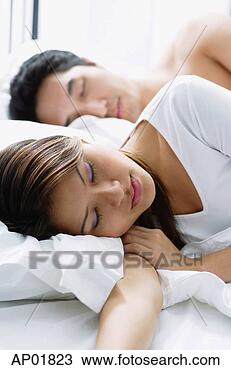 Stock Photo - couple sleeping 
on bed. fotosearch 
- search stock 
photos, pictures, 
images, and photo 
clipart