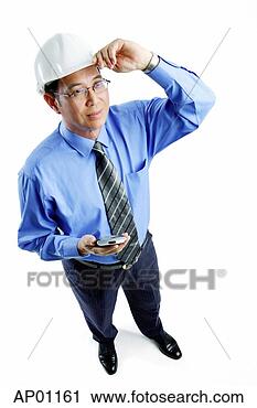 Stock Photography - man wearing hardhat 
standing, holding 
pda, looking away. 
fotosearch - search 
stock photos, 
pictures, images, 
and photo clipart