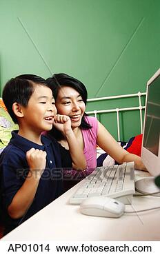 Stock Photo - mother and son 
looking at computer, 
smiling. fotosearch 
- search stock 
photos, pictures, 
images, and photo 
clipart