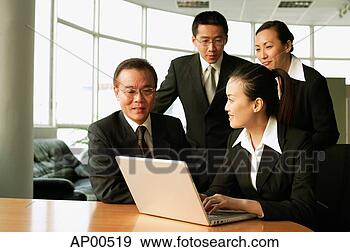 Stock Photograph - executives in 
office, sitting 
and standing around 
open laptop, talking. 
fotosearch - search 
stock photos, 
pictures, images, 
and photo clipart