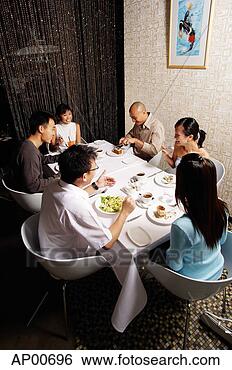 Stock Photo - group of friends 
eating at a restaurant. 
fotosearch - search 
stock photos, 
pictures, images, 
and photo clipart