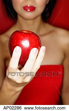 Stock Photo - woman in red tube 
tope holding red 
apple. fotosearch 
- search stock 
photos, pictures, 
images, and photo 
clipart