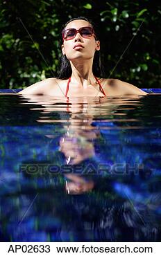 Stock Photo - woman sitting 
in swimming pool, 
head above water. 
fotosearch - search 
stock photos, 
pictures, images, 
and photo clipart