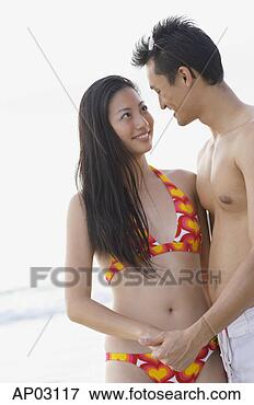 Picture - couple on beach, 
holding hands 
looking at each 
other. fotosearch 
- search stock 
photos, pictures, 
images, and photo 
clipart