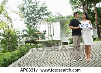 Picture - couple on driveway 
holding for sale 
sign. fotosearch 
- search stock 
photos, pictures, 
images, and photo 
clipart