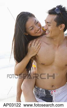 Stock Photo - man carrying woman 
on back. fotosearch 
- search stock 
photos, pictures, 
images, and photo 
clipart