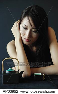 Stock Photo - woman with eyes 
closed, teacup 
and teapot next 
to her. fotosearch 
- search stock 
photos, pictures, 
images, and photo 
clipart
