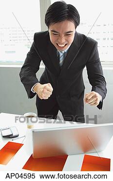 Stock Image - businessman standing, 
looking at laptop, 
making a face. 
fotosearch - search 
stock photos, 
pictures, images, 
and photo clipart