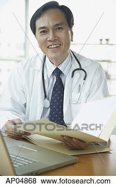 Stock Photo - doctor smiling 
at camera, holding 
folder. fotosearch 
- search stock 
photos, pictures, 
images, and photo 
clipart