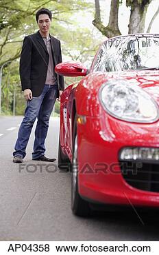 Stock Photo - man standing and 
looking at rear 
of red sports 
car. fotosearch 
- search stock 
photos, pictures, 
images, and photo 
clipart