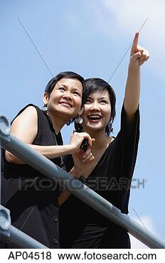 Stock Photo - two women side 
by side, one pointing 
in the distance. 
fotosearch - search 
stock photos, 
pictures, images, 
and photo clipart