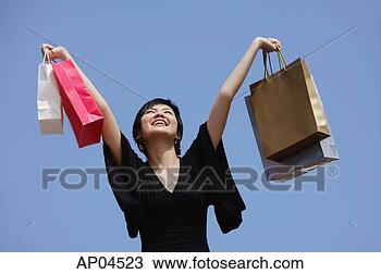 Stock Photo - woman arms outstretched, 
carrying shopping 
bags. fotosearch 
- search stock 
photos, pictures, 
images, and photo 
clipart
