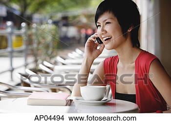 Stock Photo - woman at cafe 
using mobile phone. 
fotosearch - search 
stock photos, 
pictures, images, 
and photo clipart