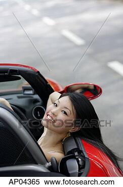 Stock Image - woman sitting 
in red sports 
car,  leaning 
head on door, 
 smiling at. fotosearch 
- search stock 
photos, pictures, 
images, and photo 
clipart