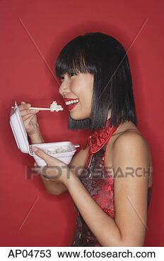 Stock Photo - woman standing 
red background, 
eating rice from 
a styrofoam container. 
fotosearch - search 
stock photos, 
pictures, images, 
and photo clipart