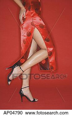 Stock Photography - woman wearing 
cheongsam and 
high heels, standing 
on one leg. fotosearch 
- search stock 
photos, pictures, 
images, and photo 
clipart