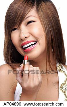 Stock Photo - young woman holding 
lipstick. fotosearch 
- search stock 
photos, pictures, 
images, and photo 
clipart