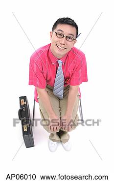 Stock Photography - businessman sitting 
on chair, smiling 
at camera, briefcase 
next to him. fotosearch 
- search stock 
photos, pictures, 
images, and photo 
clipart