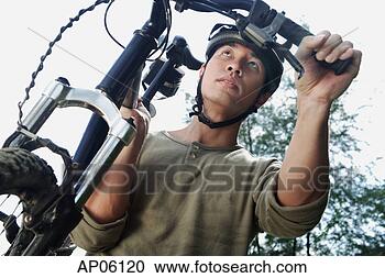 Stock Photography - man carrying bicycle, 
low angle view. 
fotosearch - search 
stock photos, 
pictures, images, 
and photo clipart