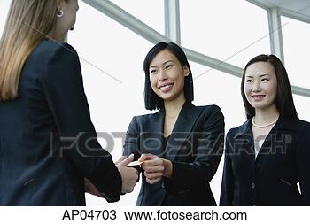 Stock Photo - three businesswomen 
exchanging business 
cards. fotosearch 
- search stock 
photos, pictures, 
images, and photo 
clipart