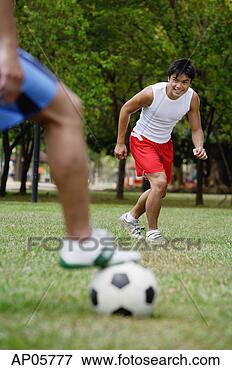 Picture - two men playing 
soccer. fotosearch 
- search stock 
photos, pictures, 
images, and photo 
clipart