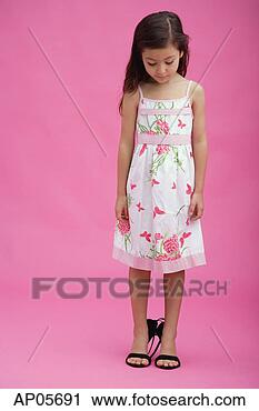 Stock Photography - young girl wearing 
high heel shoes, 
looking down. 
fotosearch - search 
stock photos, 
pictures, images, 
and photo clipart