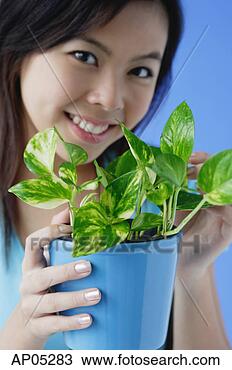 Stock Photo - young woman holding 
houseplant. fotosearch 
- search stock 
photos, pictures, 
images, and photo 
clipart