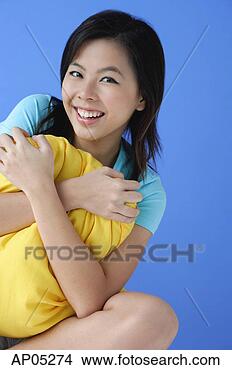 Stock Photo - young woman hugging 
pillow, portrait. 
fotosearch - search 
stock photos, 
pictures, images, 
and photo clipart