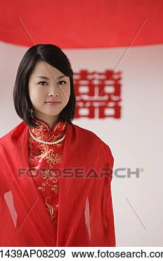 Stock Photograph - a bride wearing 
a red silk dress 
looks at the camera. 
fotosearch - search 
stock photos, 
pictures, images, 
and photo clipart