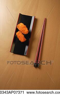 Stock Photography - two pieces of 
sushi, chopsticks, 
tobiko gunkan, 
fish roe. fotosearch 
- search stock 
photos, pictures, 
images, and photo 
clipart