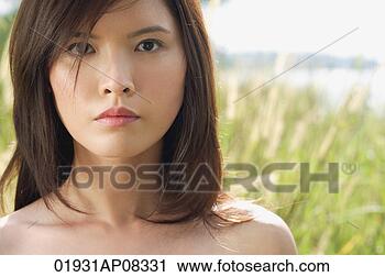 Stock Photography - woman in long 
grass looking 
at camera. fotosearch 
- search stock 
photos, pictures, 
images, and photo 
clipart