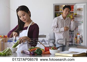 Stock Photo - young couple cooking 
in the kitchen. 
fotosearch - search 
stock photos, 
pictures, images, 
and photo clipart
