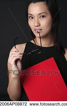 Stock Photo - young woman with 
book looking at 
camera. fotosearch 
- search stock 
photos, pictures, 
images, and photo 
clipart
