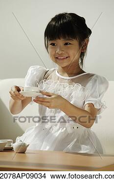 Stock Photo - girl in white 
dress playing 
with tea cups. 
fotosearch - search 
stock photos, 
pictures, images, 
and photo clipart