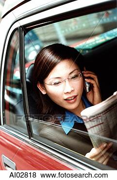 Stock Photo - executive woman 
using cellular 
phone and reading 
newspaper in taxi. 
fotosearch - search 
stock photos, 
pictures, images, 
and photo clipart