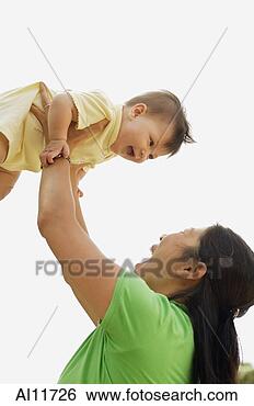Stock Photo - mother lifting 
baby girl. fotosearch 
- search stock 
photos, pictures, 
images, and photo 
clipart