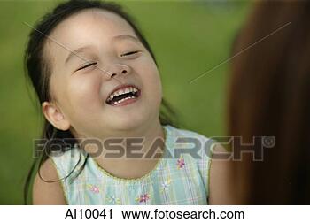 Stock Photography - young girl laughing, 
mother looking 
on. fotosearch 
- search stock 
photos, pictures, 
images, and photo 
clipart