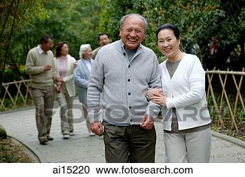 Stock Photography - couple walking 
in park,  smiling 
at camera,  other 
couples in the. 
fotosearch - search 
stock photos, 
pictures, images, 
and photo clipart