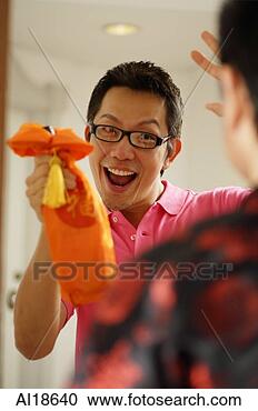 Stock Photography - man greeting visitor 
at door, holding 
wine bottle. fotosearch 
- search stock 
photos, pictures, 
images, and photo 
clipart
