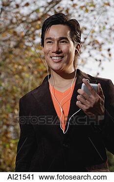 Stock Photography - man listening 
to mp3 player. 
fotosearch - search 
stock photos, 
pictures, images, 
and photo clipart
