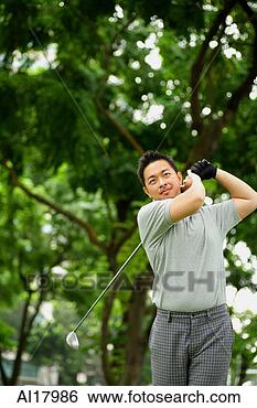 Stock Photo - man swinging golf 
club. fotosearch 
- search stock 
photos, pictures, 
images, and photo 
clipart