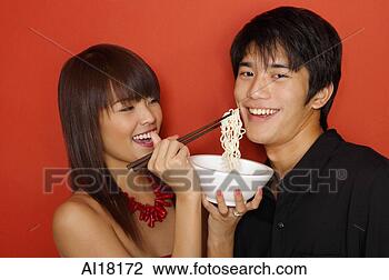 Stock Photo - young woman feeding 
man with noodles. 
fotosearch - search 
stock photos, 
pictures, images, 
and photo clipart